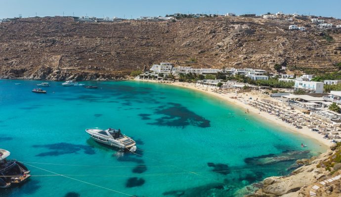 Aerial panoramic view of the famous Psarou bay in Mykonos island Greece.