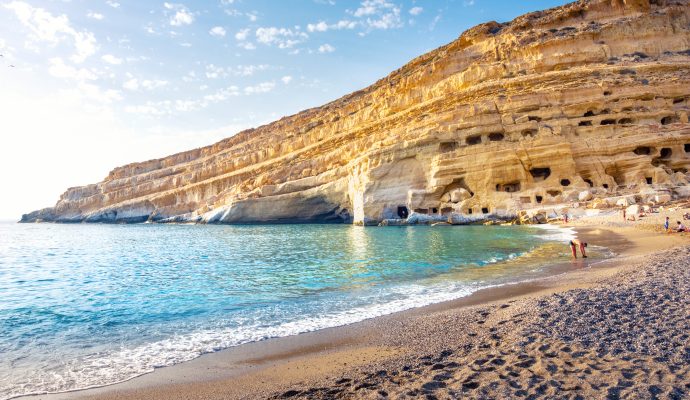 Matala Beach With Caves On The Rocks That Were Used.