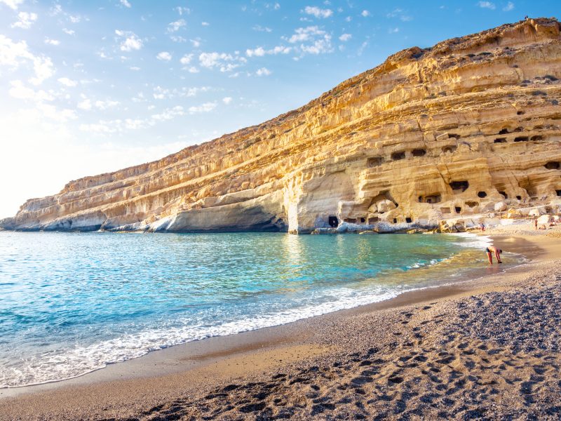 Matala,Beach,With,Caves,On,The,Rocks,That,Were,Used