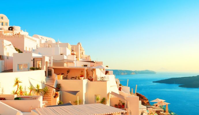 White Cycladic architecture overlooking the caldera in Santorini Greece with iconic blue sky and sea views